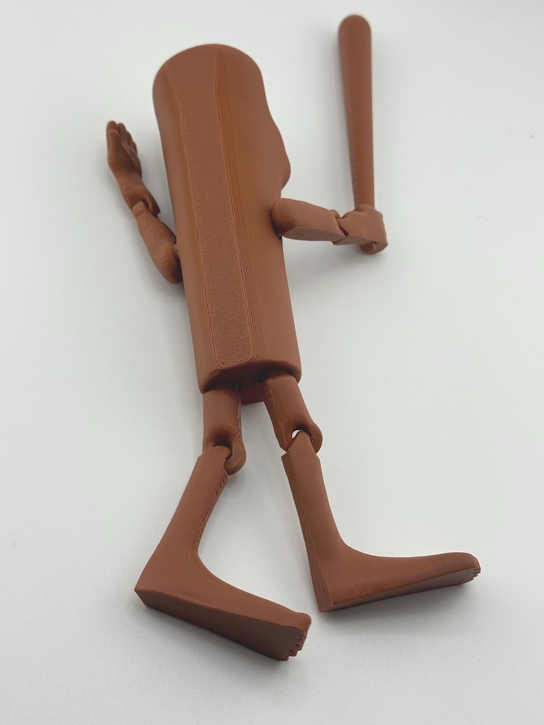 May include: A brown articulated figure holding a baseball bat. The figure has a rectangular torso, jointed limbs, and a rounded head. The baseball bat is also brown and is held in the figure's right hand.