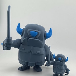 May include: Two gray figurines with blue horns and blue eye visors, each holding a gray sword. The larger figure stands on the left, while the smaller figure stands on the right. Both figures feature a bulky, armored appearance with distinct blue accents.