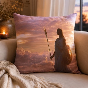 May include: Decorative throw pillow featuring a classical figure with a spear and shield against a sunset sky. The pillow has a soft, textured appearance, with a color palette of warm oranges, pinks, and purples.