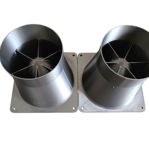 May include: Two metallic, funnel-shaped objects with a fan-like structure inside. Each object is mounted on a square base with rounded corners. The objects are angled slightly, and the overall design is industrial.