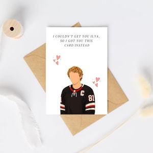 May include: A white greeting card featuring a cartoon illustration of a hockey player with curly blonde hair wearing a black jersey with the number 81 and a letter C. The text reads: I COULDN'T GET YOU ILYA, SO I GOT YOU THIS CARD INSTEAD.