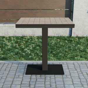 May include: A square outdoor table with a light brown tiled top and a dark gray metal base. The table has a single central support and a rectangular base. The table is set on a brick patio with grass in the background.