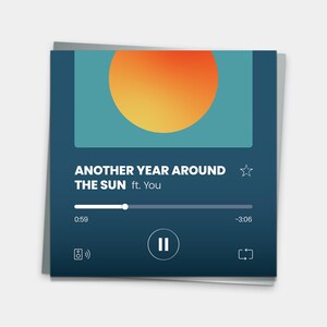 May include: A greeting card with a digital music player interface design. The card features a blue background with an orange and yellow sun graphic. Text on the card reads "ANOTHER YEAR AROUND THE SUN ft. You". The card also displays a play/pause button and a progress bar.