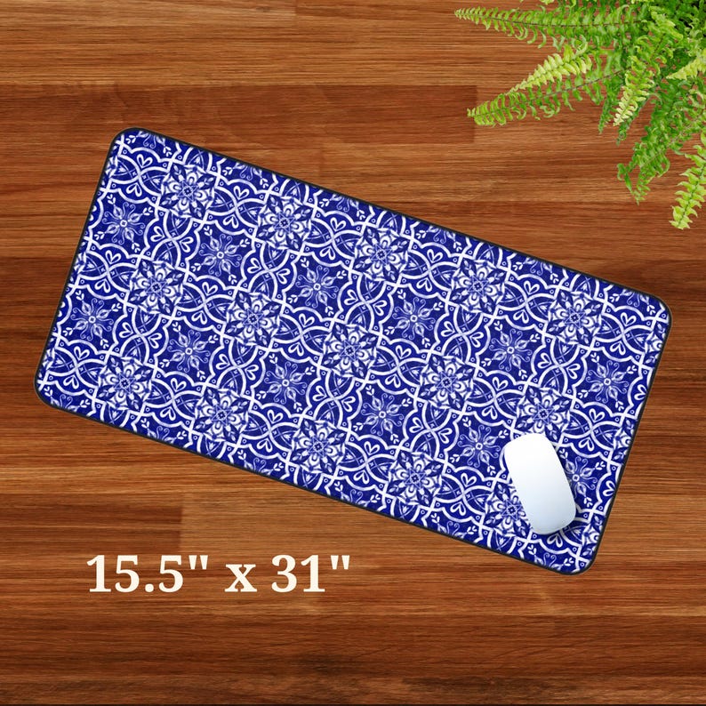 May include: A blue and white patterned mouse mat with a white computer mouse on top. The mouse mat measures 15.5 inches by 31 inches.