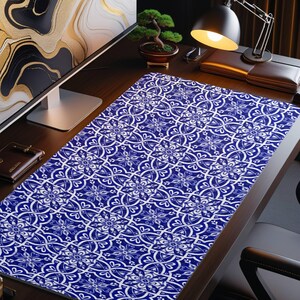 May include: A blue and white patterned desk mat with a geometric design. The mat is made of a durable material and is perfect for protecting your desk from scratches and spills.