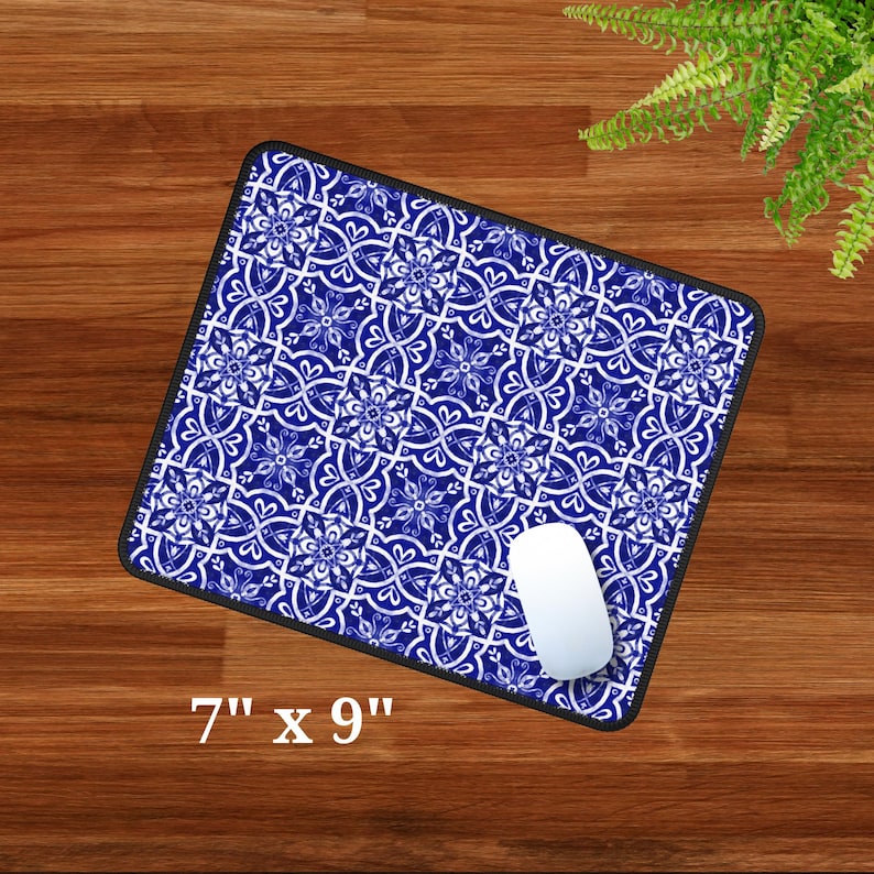May include: Blue and white patterned mouse mat with a white computer mouse on top. The mouse mat measures 7 inches by 9 inches.