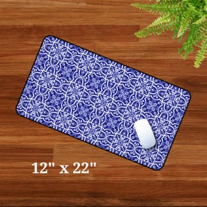 May include: A blue and white patterned mouse mat with a white computer mouse on top. The mouse mat is 12 inches by 22 inches.