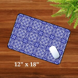 May include: Blue and white patterned mouse mat with a white computer mouse on top. The mouse mat is 12 inches by 18 inches.