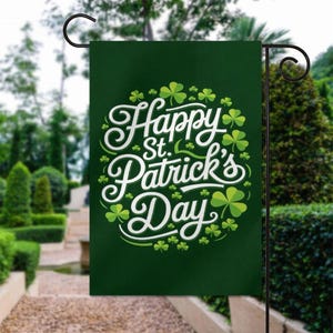 May include: A green garden flag with the text "Happy St. Patrick's Day" in white script and shamrock accents. The flag is displayed on a black metal stand in a garden setting.