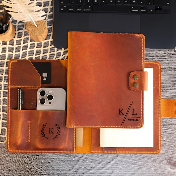 A proper monogrammed leather padfolio — the kind of desk piece that makes a $50 meeting feel like a $500 one.