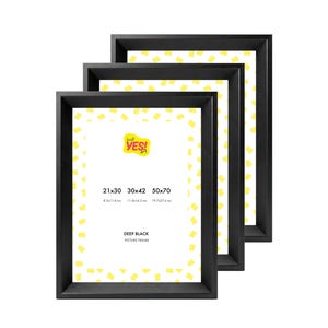 May include: Three rectangular black picture frames stacked in a staggered arrangement. The white inserts feature a yellow confetti pattern, the text "just YES! art", and dimensions of 21x30, 30x42, and 50x70 cm, with imperial equivalents 8.3x11.8, 11.8x16.5, and 19.7x27.6 inches.