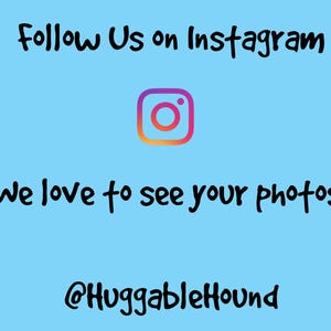 May include: A blue background with the text "Follow Us on Instagram" in black. An Instagram logo is below the text. The text "We love to see your photos!" is below the logo. The text "@HuggableHound" is at the bottom of the image.