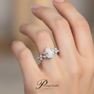 Luxurious 2 Ct pear shaped moissanite engagement ring set in yellow gold, with intricate diamond leaf vine detailing, a nature inspired vintage style ring for brides who adore timeless charm.