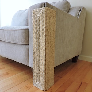 May include: A beige sofa armrest with a beige sisal rope cover to protect the furniture from cat scratches.