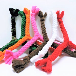 May include: Assortment of colorful, braided, fleece dog toys. Each toy has a Y-shaped design with three knotted ends. The colors include green, orange, pink, brown, white, and red.