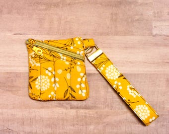 Cartera de mano acolchada con estampado floral mostaza, monedero de muñeca con llavero de flor amarilla, mini bolso dorado