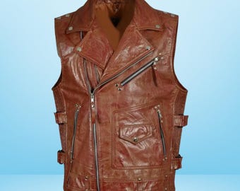 May include: A brown leather vest with a classic biker style. The vest features a notched collar, multiple zippered pockets, and silver-toned hardware. It has a front zipper closure and adjustable side straps for a custom fit.