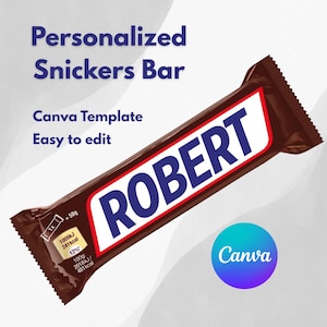 May include: A personalized Snickers bar with the name "ROBERT" in large blue letters on a white background. The chocolate bar is in a brown wrapper, with nutritional information and the Canva logo visible.