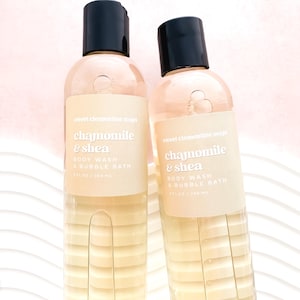 May include: Two clear bottles of chamomile and shea body wash and bubble bath. The bottles are labeled "sweet clementine soaps" and have a light yellow liquid inside.