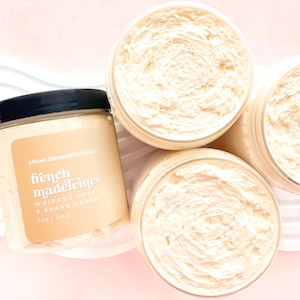 May include: Three jars of whipped soap and shave cream with a sweet clementine scent. The jars are labeled "sweet clementine soap" and "french madeleines whipped soap & shave cream".