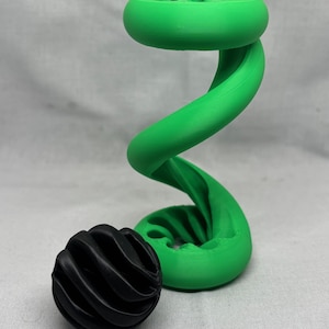 以下が含まれることがあります： 緑色の3Dプリントされたらせん状の彫刻と、黒色の3Dプリントされた球体
