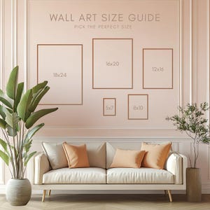 May include: A wall art size guide with brown frames in various sizes: 18x24 inches, 16x20 inches, 12x16 inches, 5x7 inches, and 8x10 inches. The text "WALL ART SIZE GUIDE" and "PICK THE PERFECT SIZE" are displayed above the frames. A white sofa with orange pillows is in front of the wall.