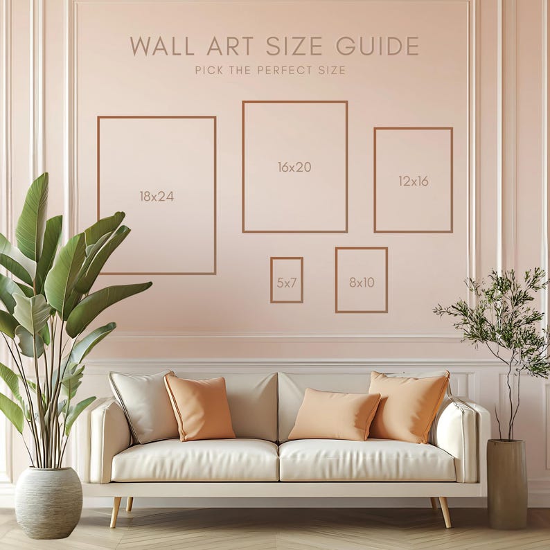 May include: A wall art size guide with brown frames in various sizes: 18x24 inches, 16x20 inches, 12x16 inches, 5x7 inches, and 8x10 inches. The text "WALL ART SIZE GUIDE" and "PICK THE PERFECT SIZE" are displayed above the frames. A white sofa with orange pillows is in front of the wall.