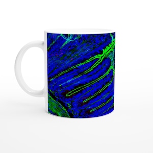 May include: White ceramic mug with a striking abstract pattern in blue and green. The design has a textured look with linear and organic forms. The mug has a standard handle and a glossy finish, ideal for hot drinks, with a capacity of approximately 300 ml.