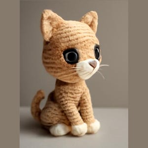 May include: A crocheted plush cat toy with brown fur, large black eyes, and a white nose and whiskers.