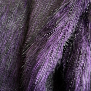 Peut inclure: Gros plan sur un tissu de fausse fourrure violet vif. Le tissu présente de longues fibres douces avec un mélange de teintes violettes, noires et grises, créant un aspect texturé et luxueux. La fourrure est probablement utilisée pour des vêtements ou des projets d'artisanat.