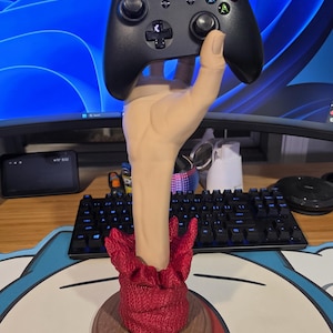 May include: A white ceramic mug with a black handle and the text "But First, Coffee" in a bold, black font. The mug is set against a neutral background, highlighting its simple design.