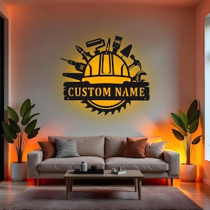 Może przedstawiać: Czarna metalowa grafika ścienna przedstawiająca narzędzia budowlane, kask i piłę tarczową. Tekst "CUSTOM NAME" jest wyświetlany na banerze. Grafika jest podświetlona ciepłą żółtą poświatą.