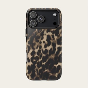 May include: A smartphone case with a leopard print design. The case is primarily brown and black, with a glossy finish. The camera lenses are visible at the top.