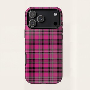 May include: A hot pink phone case with a black and white plaid pattern. The case has a glossy finish and features a camera module with three lenses. The design is a classic tartan style, offering a bold and stylish look for the phone.