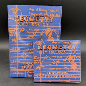 May include: Two geometry textbooks and CDs with orange and white text on a blue background. The larger book reads "GEOMETRY SOLUTIONS CDS" and the smaller one reads "GEOMETRY TEST SOLUTIONS CD". Diagrams and mathematical terms are also visible.