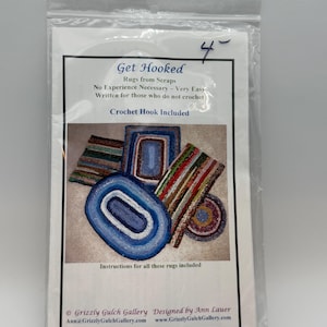 May include: A clear plastic bag containing a white paper with the text "Get Hooked" and images of colorful rugs. The text indicates the product is for making rugs from scraps, with a crochet hook included.