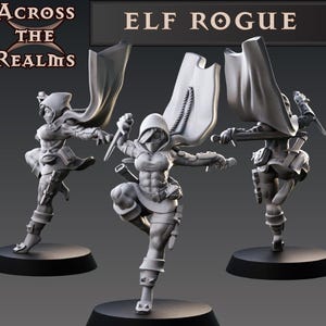 May include: Three miniature figurines of an elf rogue, each in a different pose. The elf is wearing a hooded cloak and holding a dagger. The figurines are painted in a gray color.