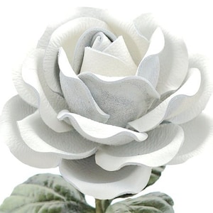 May include: A white leather rose with a delicate, layered design. The rose is crafted with intricate details and has a soft, velvety texture.