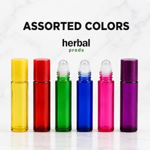 May include: Six cylindrical glass roller bottles with plastic caps in yellow, red, green, blue, pink, and purple. The text ASSORTED COLORS and herbal prods is printed above the bottles. Each bottle features a clear plastic roller ball top.
