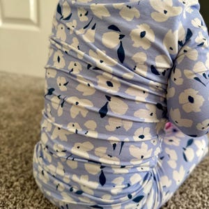 Blue floral bamboo baby pajama with soft white flower print, long-sleeve zip-up one-piece featuring fold-over mittens and feet, a tagless neckline for sensitive skin, and a convenient 2-way zipper—comfortable, breathable infant sleeper for girls. two piece toddler set for sleeps wear. super soft and breathable