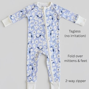 Blue floral bamboo baby pajama with soft white flower print, long-sleeve zip-up one-piece featuring fold-over mittens and feet, a tagless neckline for sensitive skin, and a convenient 2-way zipper—comfortable, breathable infant sleeper for girls.