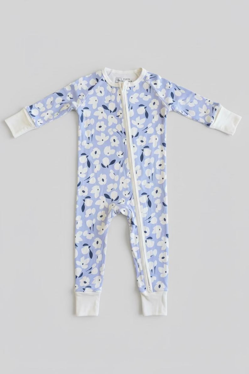 periwinkle blue bamboo baby pajama with white and blue flowers. bamboo pajama is soft, breathable and perfect to keep your little one cool. bamboo pajama is a double zipper and convertible.