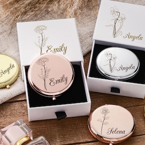 May include: Compact mirrors in gold, rose gold, and silver, each with a floral design and personalized name. The mirrors are in white boxes with matching floral accents. A stylish and personalized gift.