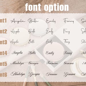 May include: An image showcasing font options for personalized items. The text "font option" is at the top. Six font styles are displayed, each with sample names like Angela, Belle, and Emily. The fonts are in black script, presented on a light background.