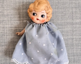 Antique Japan Bisque Porcelain Kewpie Doll with Blue dress, Strung arms, Blonde Hair