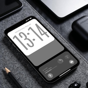 May include: A smartphone displaying a digital clock widget showing 13:14 and the date Wednesday, May 20. The screen features a white background for the time and a dark gray section below with weather information indicating 50% rain today.