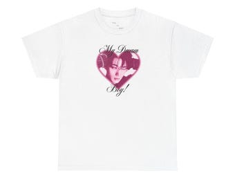 May include: White t-shirt featuring a pink heart design with a portrait and the text "My Dream Boy!". The graphic is centered on the front of the shirt.