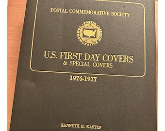 May include: A black album with gold lettering and a gold emblem. The cover reads "POSTAL COMMEMORATIVE SOCIETY" and "U.S. FIRST DAY COVERS & SPECIAL COVERS 1976-1977." The name "KENNETH R. KASTEN" is printed at the bottom.