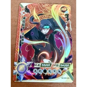 May include: A rectangular collectible trading card featuring a dark-haired anime character in a black cloak with red cloud patterns. The card displays the text SSR, Japanese characters, and numerical values of 55000 and 54000 with a metallic finish.