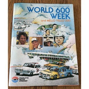 May include: A vintage 1981 souvenir magazine cover featuring race cars and portraits of race car drivers. The cover includes the text "WORLD 600 WEEK and MELLO YELLO 300" and the Charlotte Motor Speedway logo. The magazine is in good condition.
